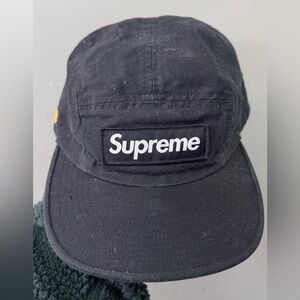 Supreme Military Camp Cap in black cotton with yellow "SUPNY-20" embroidery.